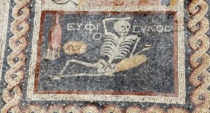 HATAY, TURKEY - APRIL 20: 2,400 year-old mosaic, discovered during excavations, saying "Be cheerful, enjoy your life" in Ancient Greek language is seen in southern Hatay province of Turkey, on April 20, 2016. Mosaic depicts lying down skeleton with a jorum in his hand together with a wine pitcher and bread. (Photo by Halit Demir/Anadolu Agency/Getty Images)